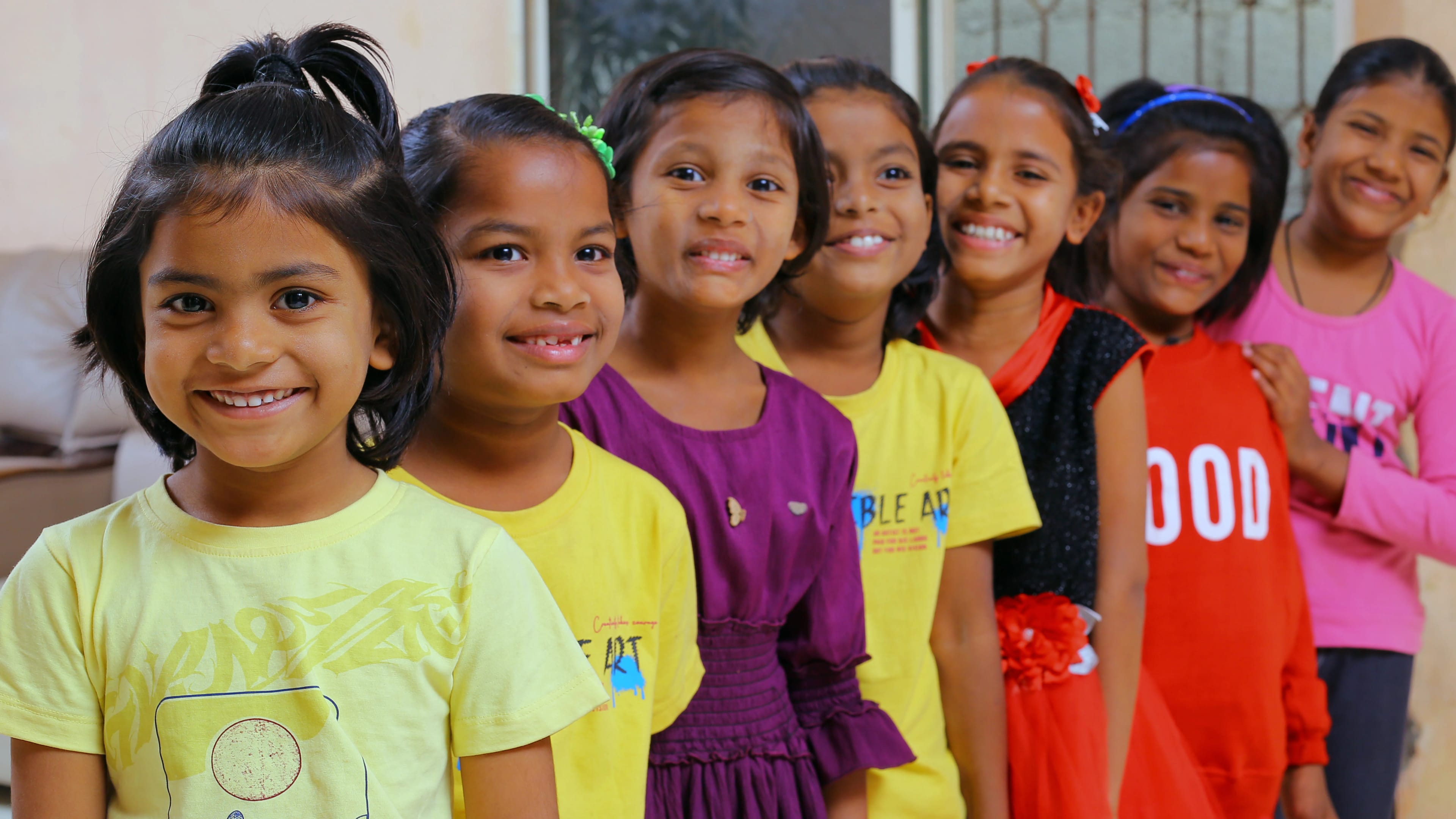 Aadarana Trust children smiling and playing together in the home courtyard